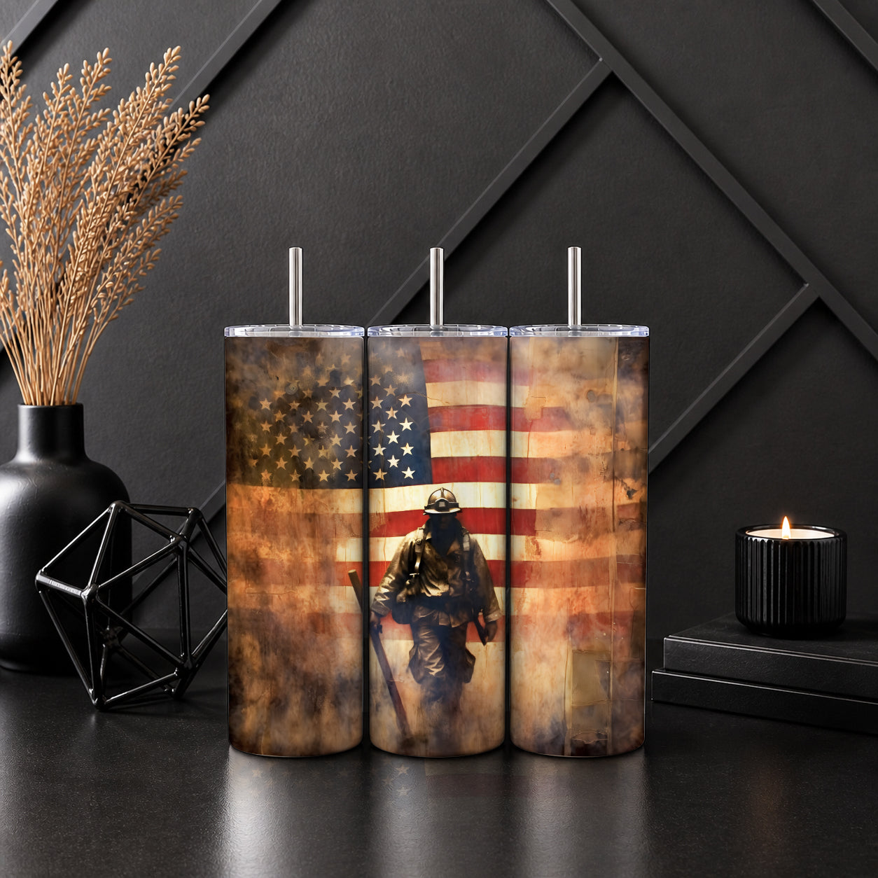 Three tall tumblers with a rustic American flag and firefighter design, part of the Patriotic Firefighter American Flag Tumbler – Rustic USA Hero Tribute Drinkware collection on a dark surface near decorative items.