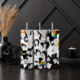 Three stainless steel tumblers with colorful black-and-white illustrations of diverse people and rainbow details on a dark modern table, featuring the Love Is Love Pride Tumbler – LGBTQ Rainbow Inclusive Drinkware.