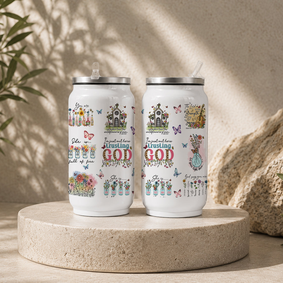Two white tumblers with floral and butterfly designs featuring scripture phrases about trust and faith, labeled Trusting God Christian Floral – Faith Inspirational Scripture Drinkware.