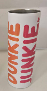 White tumbler with bold orange and pink text reading Dunkin Junkie, featuring a stainless steel interior, called Dunkin Junkie 20oz Skinny Tumbler